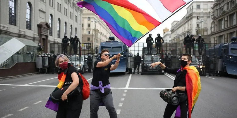 People marching at an anti-government protest wave a pride flag alongside the white-red-white flag of Belarus in Minsk, Belarus, on Sept. 6, 2020.